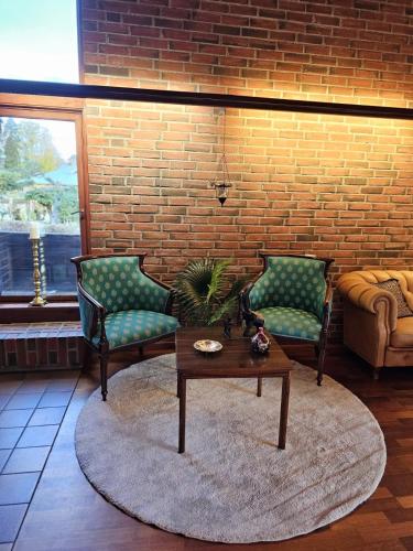 a living room with two chairs and a coffee table at Private room - 1 in a luxury villa CHALET STYLE in Oslo