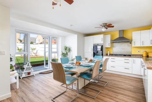 a kitchen and dining room with a table and chairs at Home in Patchway in Bristol