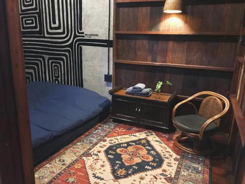 a room with a bed and a chair and a table at mrhandsome phayao in Ban Mae Ka Hua Thung