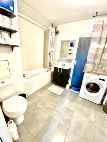 La salle de bains est pourvue de toilettes et d'un lave-linge. dans l'établissement Appartement cosy - balcon - parking gratuit - 10min centre ville, à Cenon