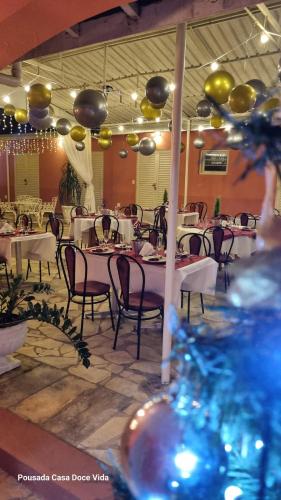 a dining room with tables and chairs and balloons at Pousada Casa Doce Vida in Águas de Lindóia