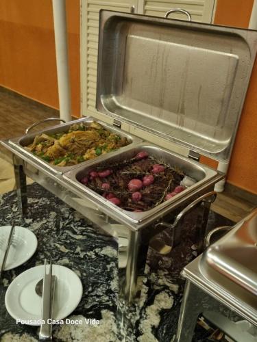 a buffet of food on a counter in an oven at Pousada Casa Doce Vida in Águas de Lindóia