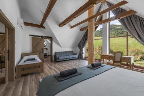 a bedroom with a large bed and a large window at Chalet Liptov Izipovce in Ižipovce