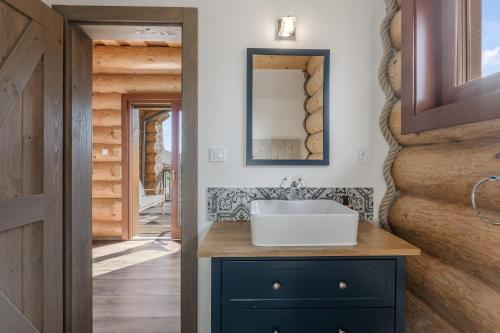 a bathroom with a sink and a mirror at Chalet Liptov Izipovce in Ižipovce