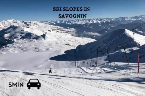 a car driving down a snow covered ski slope at Pool & Sauna Wellness Charming Swiss style chalet! in Salouf