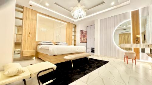 a bedroom with a bed and a large mirror at Bplayluxury in Ogoyo