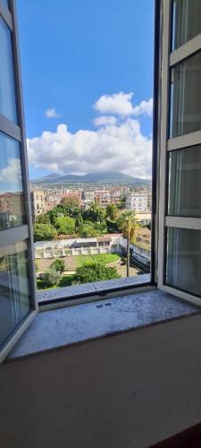 an open window with a view of a city at La Casa di Mary in Ercolano