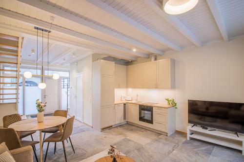 cocina y sala de estar con mesa y TV en Lai Residence Apartment 1, en Tartu