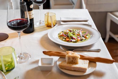 a table with a plate of food and a glass of wine at Borgo Di Celle in Città di Castello