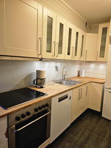 a kitchen with white cabinets and a sink at Private room - 6 in a luxury villa CHALET STYLE in Oslo