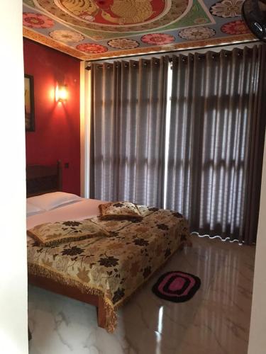 a bedroom with a bed in front of a window at Dilainya Homestay Mirissa in Mirissa