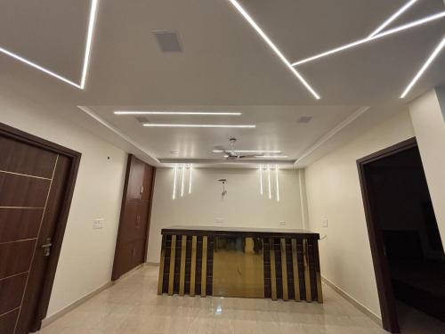 a room with white walls and a ceiling with lights at S Square HomeStay in Tājganj