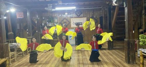 a group of children are performing on a dance floor at Thao Ly Homestay Mai Chau in Hòa Bình