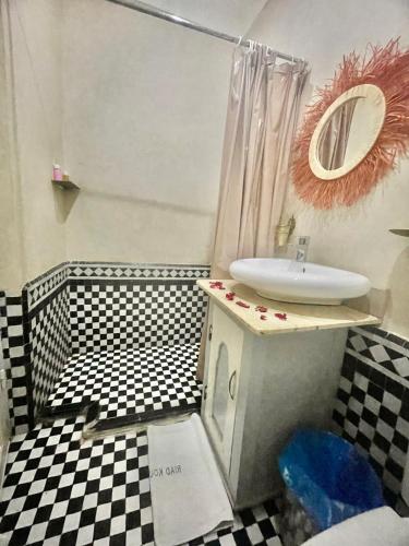 a bathroom with a sink and a mirror in it at KOUTOBIA ROYAL in Marrakech