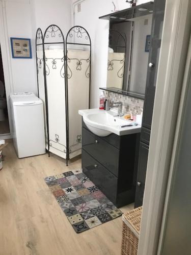 une salle de bain avec un lavabo et un miroir dans l'établissement Le CROISIC Centre Historique, au Croisic