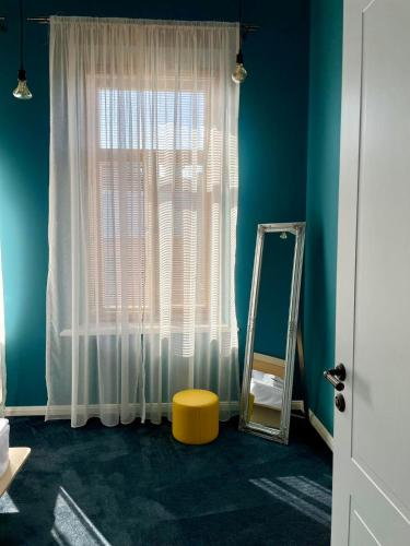 a room with a window with a mirror and a mirror mirror at Communa Good Vibes in Tbilisi City