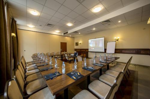 a conference room with a long table and chairs at Hotel Great Polonia Conrad Kraków in Kraków