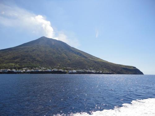a mountain in the middle of a body of water at Blu Tropical Resort in Zambrone