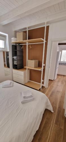 a bedroom with a large bed and shelves at Corte San Pietro -Apartments in Molfetta