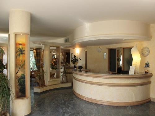 a lobby with a round counter in a building at Blu Tropical Resort in Zambrone