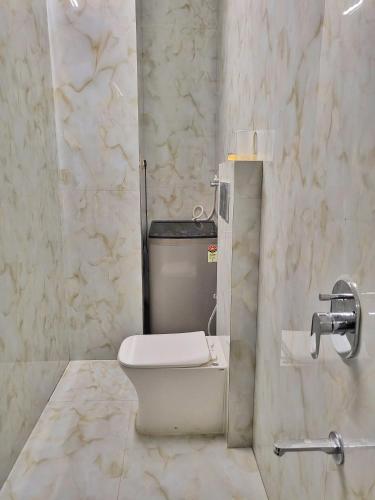 a bathroom with a toilet and a sink at Wadhwani's Haveli villa in Royal Palms in Mumbai