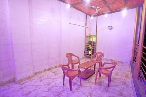 a room with a table and chairs and a wine cellar at Wadhwani's Haveli villa in Royal Palms in Mumbai