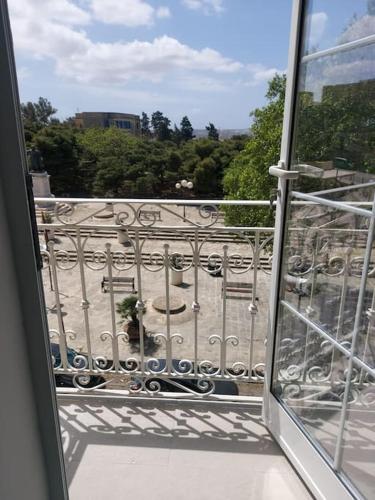 a view of a balcony with a view of a yard at Studio Suite near Valletta in Il-Furjana