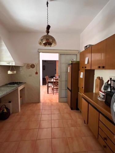 a kitchen with a table and a dining room at Casa dei nonni in San Giovanni Suèrgiu