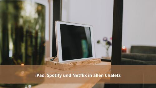 a computer monitor sitting on top of a table at Chalet WaldHäusl luxuriöse Ferienwohnungen mit Sauna & Whirlpool, Kamin, Balkon oder Terrasse mit Bergblick in Heiligenblut