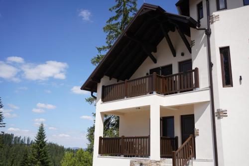 a house with balconies on the side of it at Star Hill Apartments in Nova Varoš