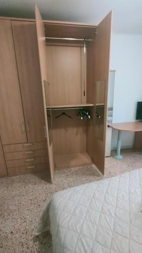 a large wooden cabinet in a bedroom with a bed at Luna Normanna in Rutigliano