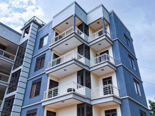 a blue building with white balconies on it at Teddy Homestay in Makindye