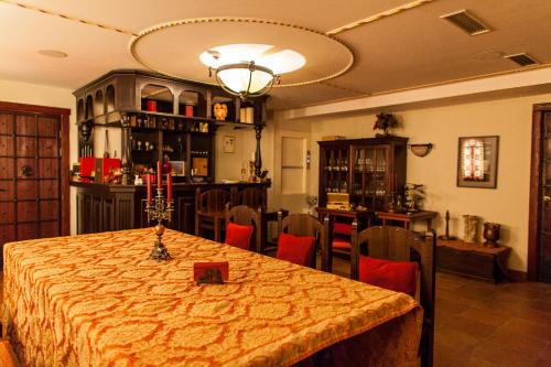 a dining room with a table and chairs and a light at TB Palace Hotel & SPA in Jūrmala