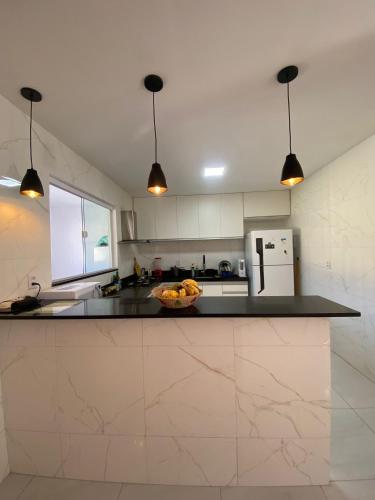 a kitchen with a bowl of fruit on a counter at Casa Macao Tibau do Sul in Tibau do Sul
