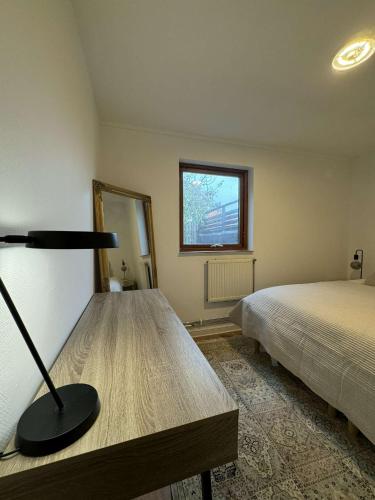 a bedroom with a bed and a lamp in it at Private apartment malmö in Malmö