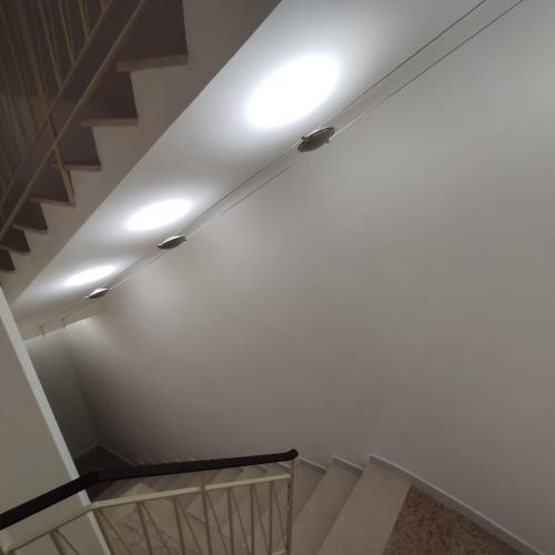 a staircase with a white ceiling with a light on it at Luna Normanna in Rutigliano