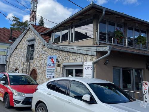 a white car parked in front of a building at Yugoslavija 2 centar in Aleksandrovac
