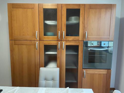 a kitchen with wooden cabinets and a stove and oven at Casa MontOrfano Erbusco in Erbusco