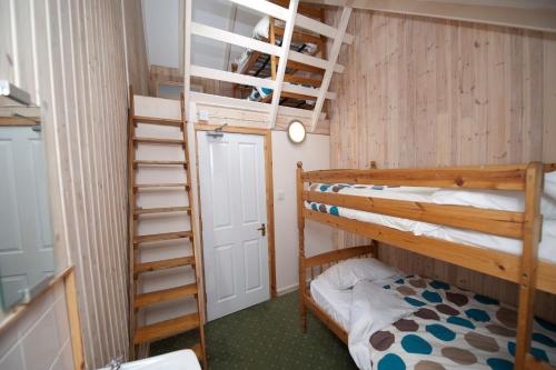a bunk bed room with two bunk beds and a ladder at Gulabin Lodge in Glenshee