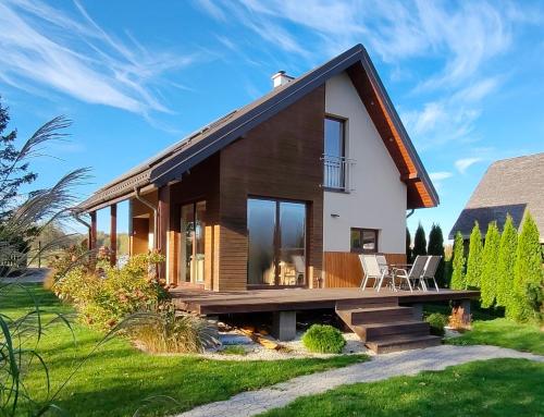 a small house with a large window and wooden at Relax Houses - Domy Mazur in Małkinie