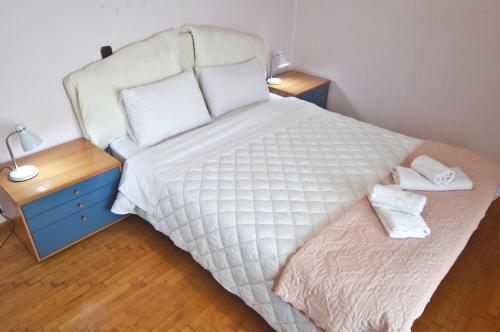 a bedroom with a large bed with two night stands at tania's view in Kastoria