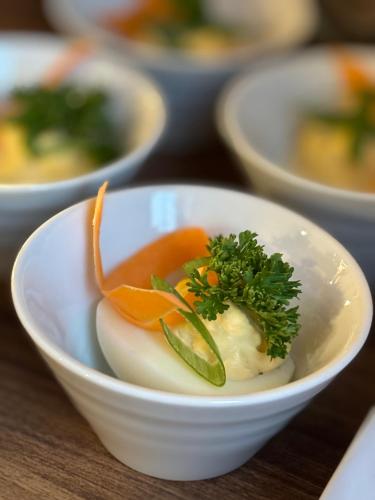 a white bowl with vegetables in it on a table at Pension U Draka in Karlovy Vary