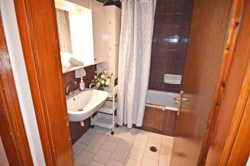 a bathroom with a sink and a bath tub at tania's view in Kastoria