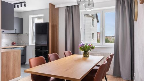ObłużeにあるGdynia City View Roomsの木製のテーブルと椅子のあるキッチンとダイニングルーム