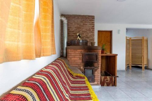 a living room with a couch and a fireplace at Casa, Bosque y Mar in Miramar