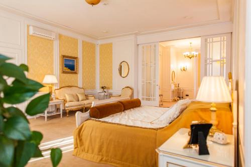 a bedroom with a large bed and a living room at TB Palace Hotel & SPA in Jūrmala