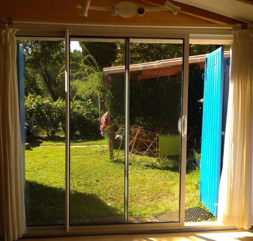 a sliding glass door with a view of a yard at La restanque in La Tour-dʼAigues