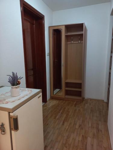 an empty room with a kitchen and an open door at Apartman Lotus in Kiseljak