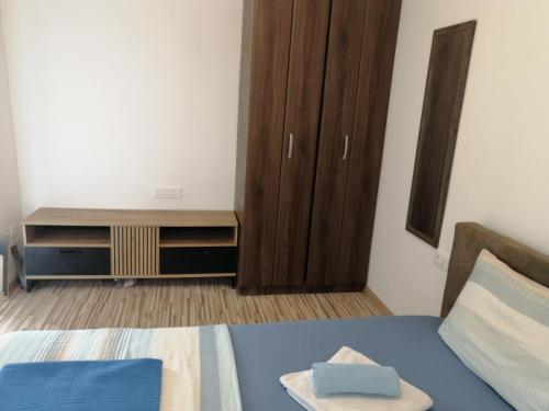 a bedroom with a bed and a dresser and a cabinet at Apartments Željka-Dobrota in Kotor