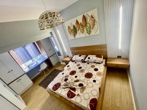 a bedroom with a bed and a pendant light at Your home Fier 1 in Fier